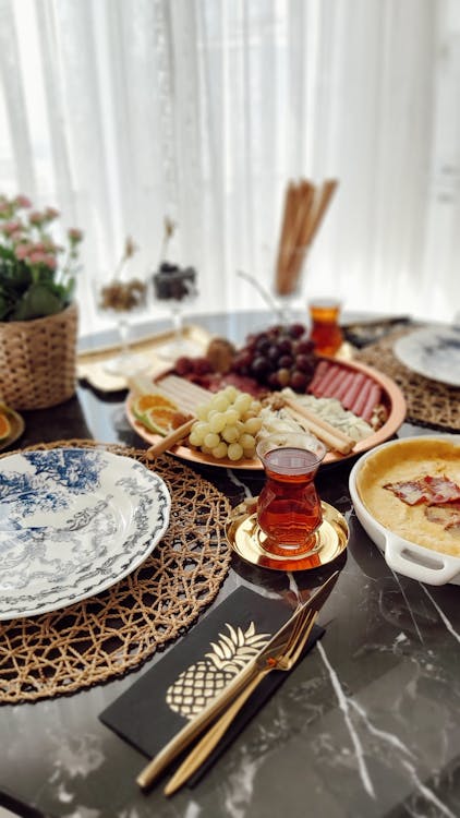 Platters with Food and Turkish Tea on Table